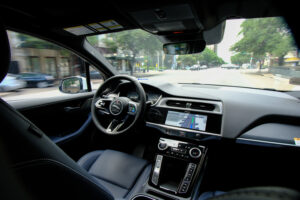 back seat view of self driving car interior - Who is liable in a self driving car accident?