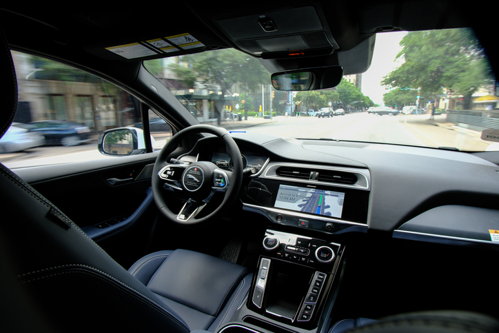 back seat view of self driving car interior - Who is liable in a self driving car accident?