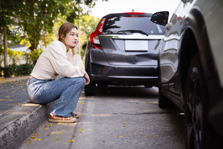 Woman contemplating after a car accident: How long after a car accident can you claim injury?
