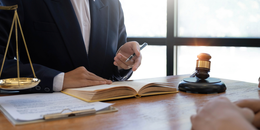 closeup of lawyer referencing a book during meeting at desk - what happens after deposition in personal injury case in Nashville, TN?