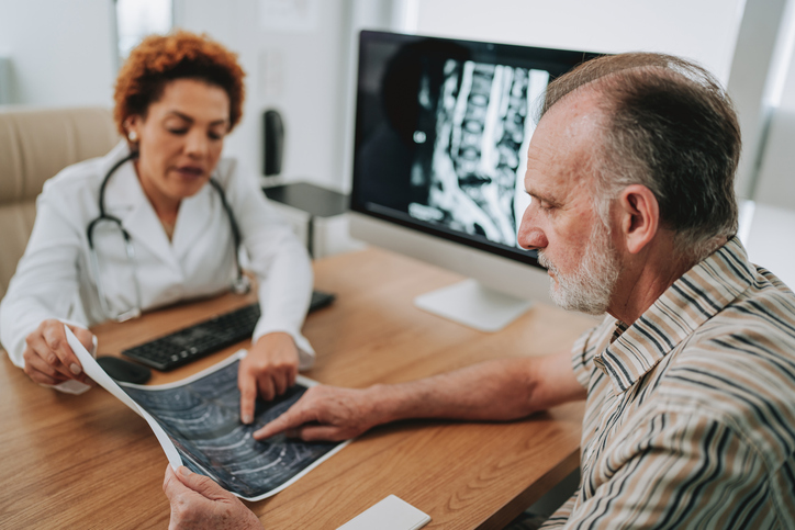 Doctor and patient discussing spine scans - Can an auto accident cause a herniated disc?