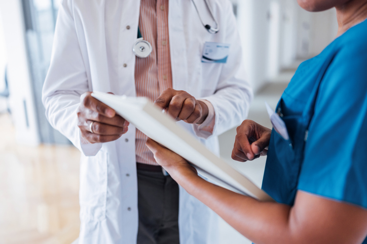 Doctors reviewing patient records - car accident aggravated pre-existing condition settlement